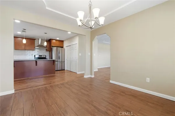 a view of a kitchen with wooden floor and a kitchen