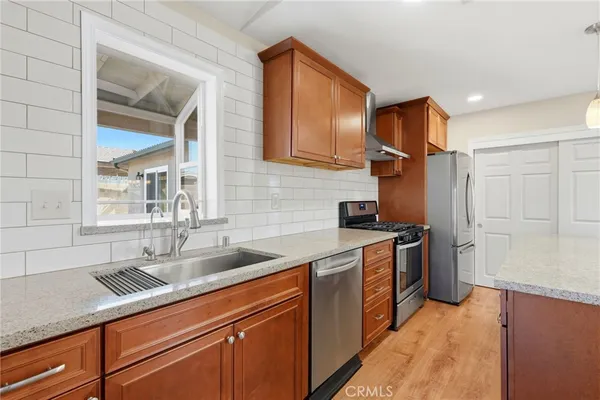 a kitchen with a sink and a refrigerator
