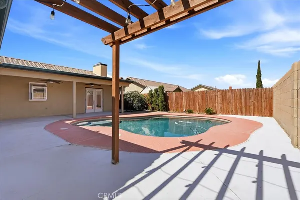 a view of a house with swimming pool and a yard