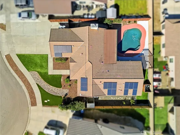 an aerial view of residential house with outdoor space and swimming pool