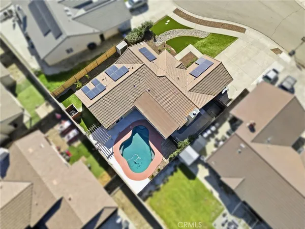 front view of a brick house with a yard