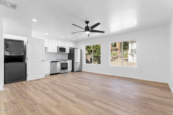 a view of a kitchen with a stove cabinets and wooden floor