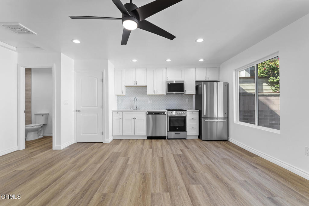 3308 Primavera Street Pasadena, CA 91107 - Photo 12 of 26 a kitchen with stainless steel appliances a refrigerator a sink a stove and white cabinets