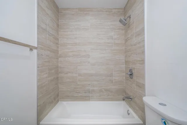 a bathroom with a shower and a toilet