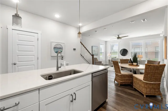 a living room with furniture and view of kitchen