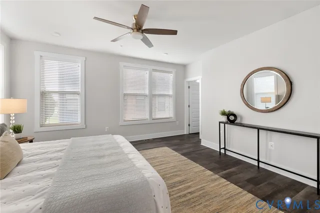 a bedroom with a bed a window and a chandelier