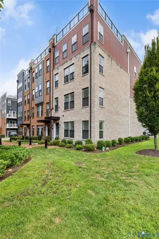 a view of a tall building with a yard