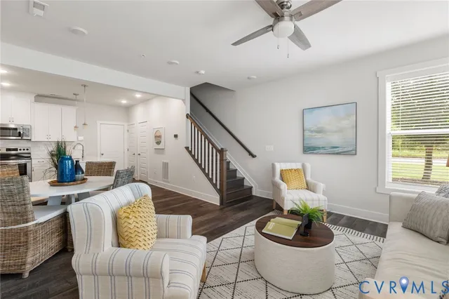 a living room with furniture and a wooden floor