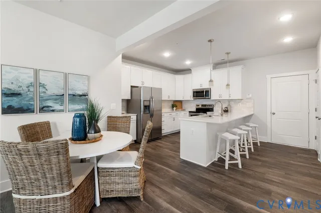 a kitchen with dining area and wooden floor