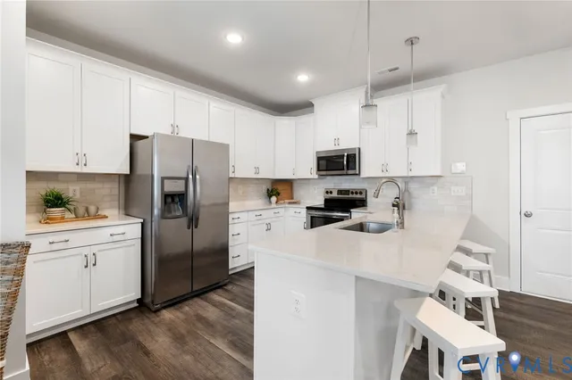 a kitchen with stainless steel appliances a refrigerator sink and microwave