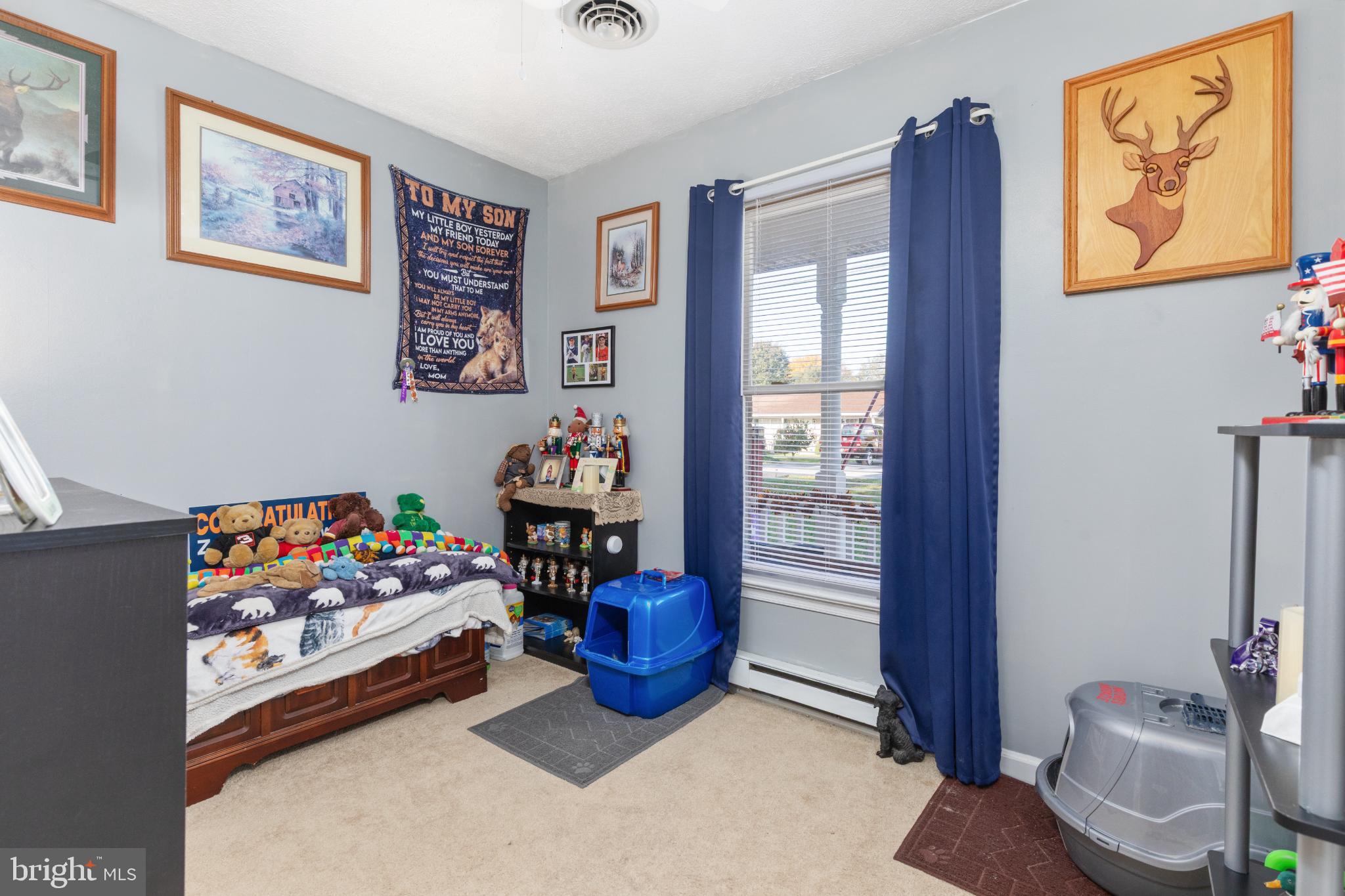 63 Declaration Drive Inwood, WV 25428 - Photo 18 of 25 a living room with painting on the wall and a dresser