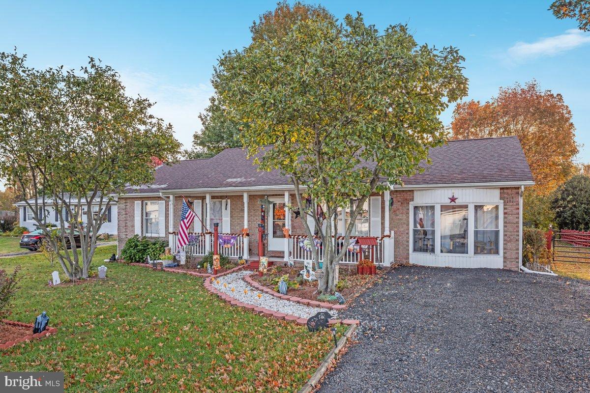 63 Declaration Drive Inwood, WV 25428 - Photo 20 of 25 a front view of a house with a yard table and chairs