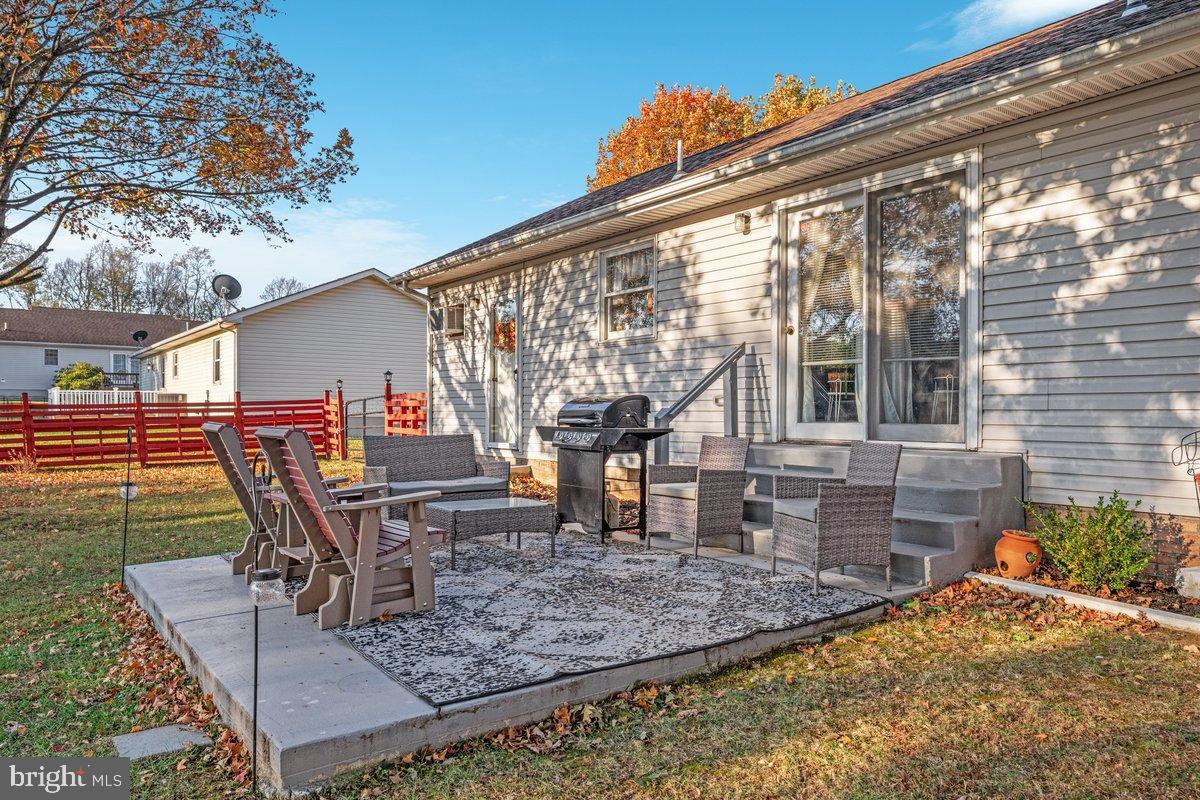 63 Declaration Drive Inwood, WV 25428 - Photo 24 of 25 a view of a patio with table and chairs with wooden floor and fence