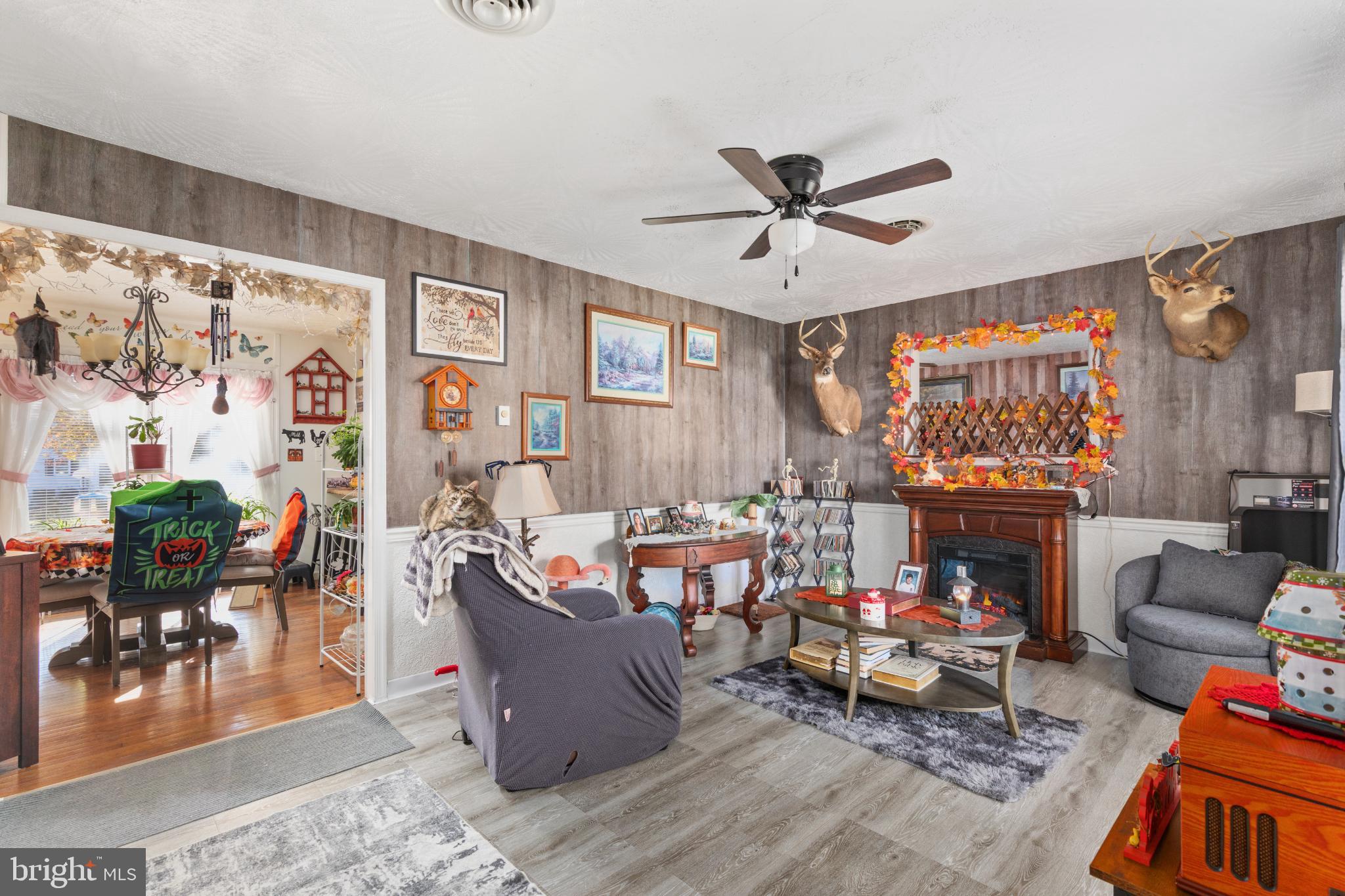 63 Declaration Drive Inwood, WV 25428 - Photo 6 of 25 a living room with furniture a fireplace and a large window