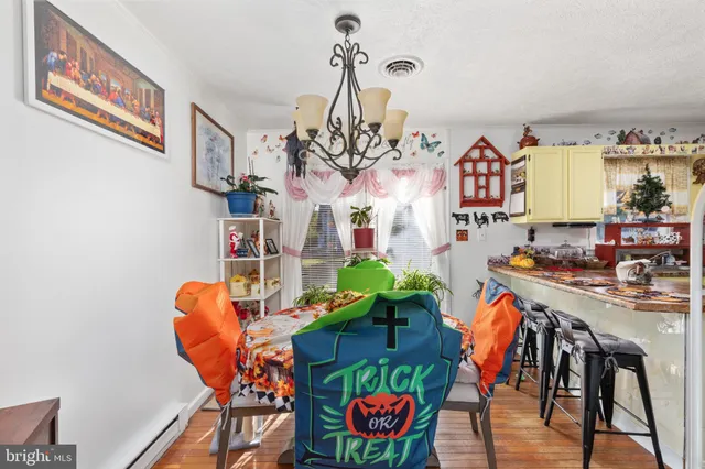 a view of a dining room with furniture and a chandelier