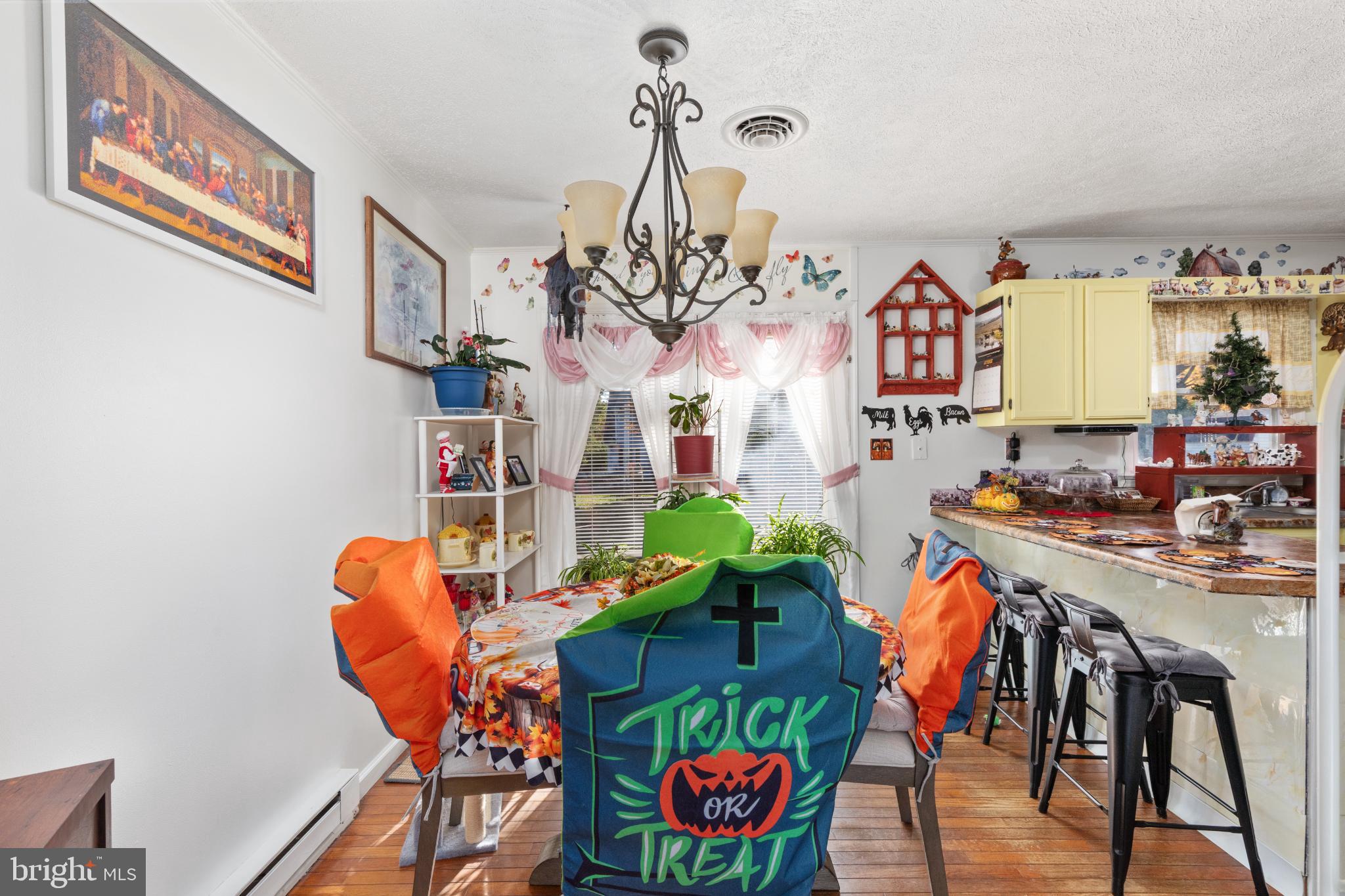 63 Declaration Drive Inwood, WV 25428 - Photo 10 of 25 a view of a dining room with furniture and a chandelier