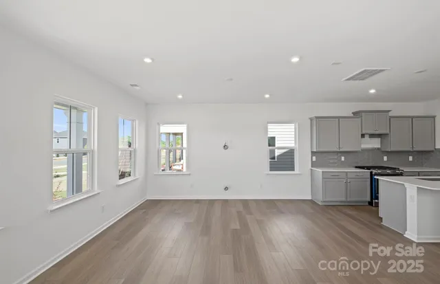 a view of a kitchen with a sink wooden floor and windows