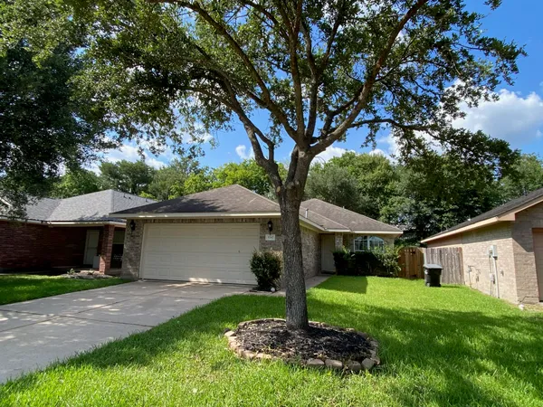 a front view of a house with a yard and a garage
