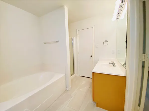 a bathroom with a bathtub and shower