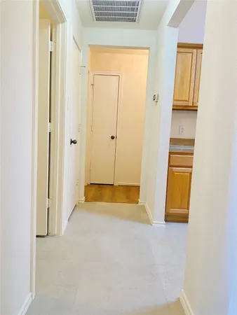 a view of an empty room with closet and windows