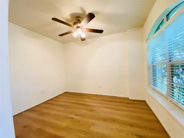 a view of a big room with wooden floor closet and windows