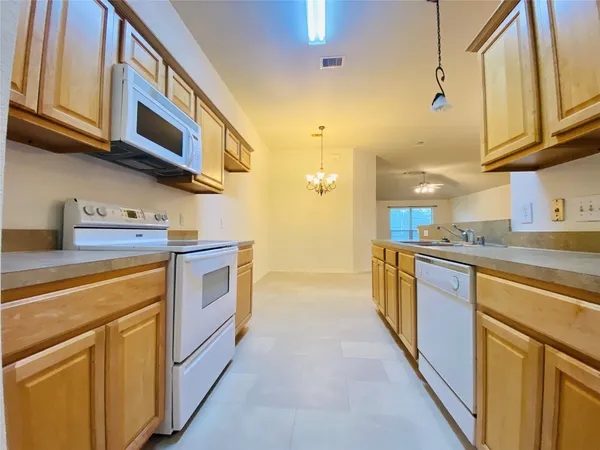 a kitchen with stainless steel appliances granite countertop a stove and a refrigerator