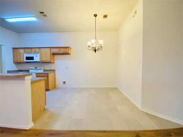 a view of kitchen with cabinets and wooden floor