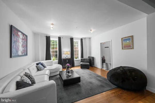 a living room with furniture and a mirror