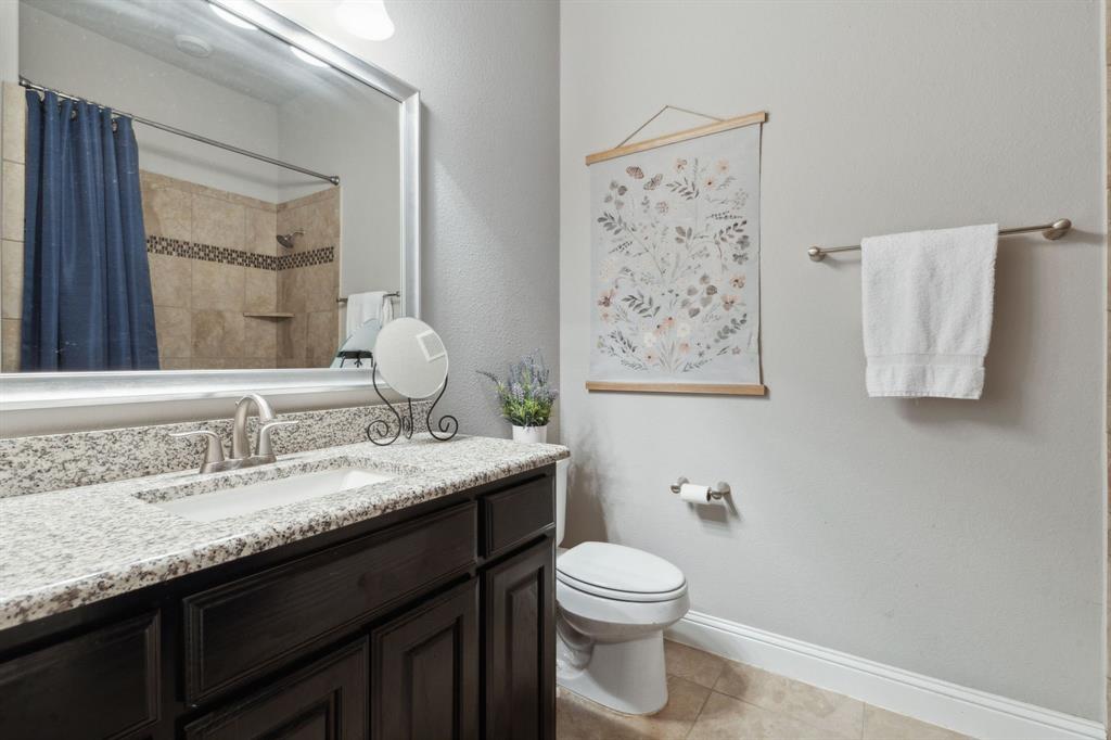 2610 Sunset Bay Lane Nevada, TX 75173 - Photo 30 of 34 a bathroom with a granite countertop sink a toilet and a mirror