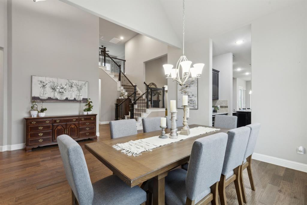 2610 Sunset Bay Lane Nevada, TX 75173 - Photo 8 of 34 a dining room with furniture a chandelier and wooden floor