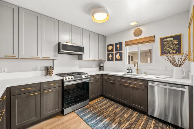 a kitchen with a stove a sink and a window