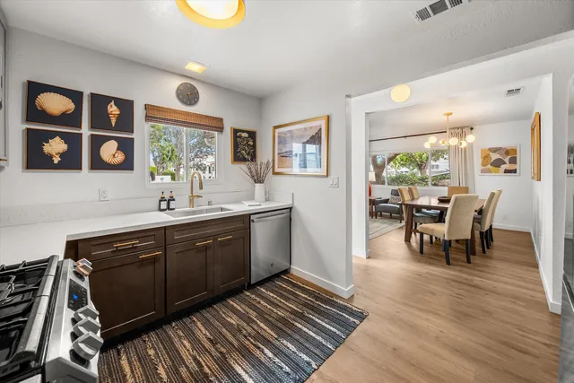 a bedroom with a bed a computer on desk and a chair