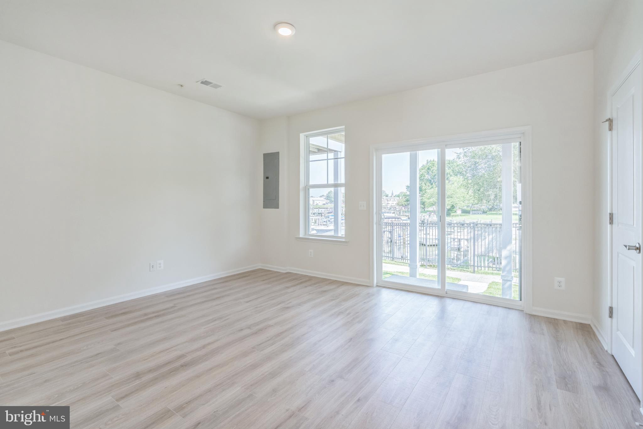2 Riverside Wharf Cambridge, MD 21613 - Photo 16 of 38 an empty room with wooden floor and windows