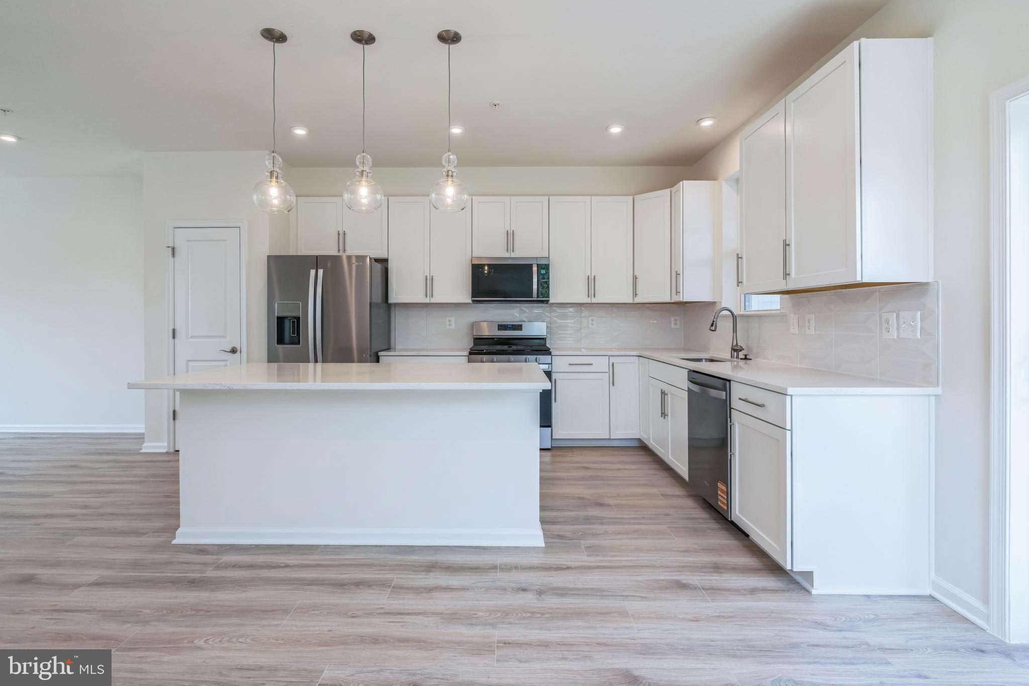 2 Riverside Wharf Cambridge, MD 21613 - Photo 4 of 38 a large kitchen with cabinets and stainless steel appliances