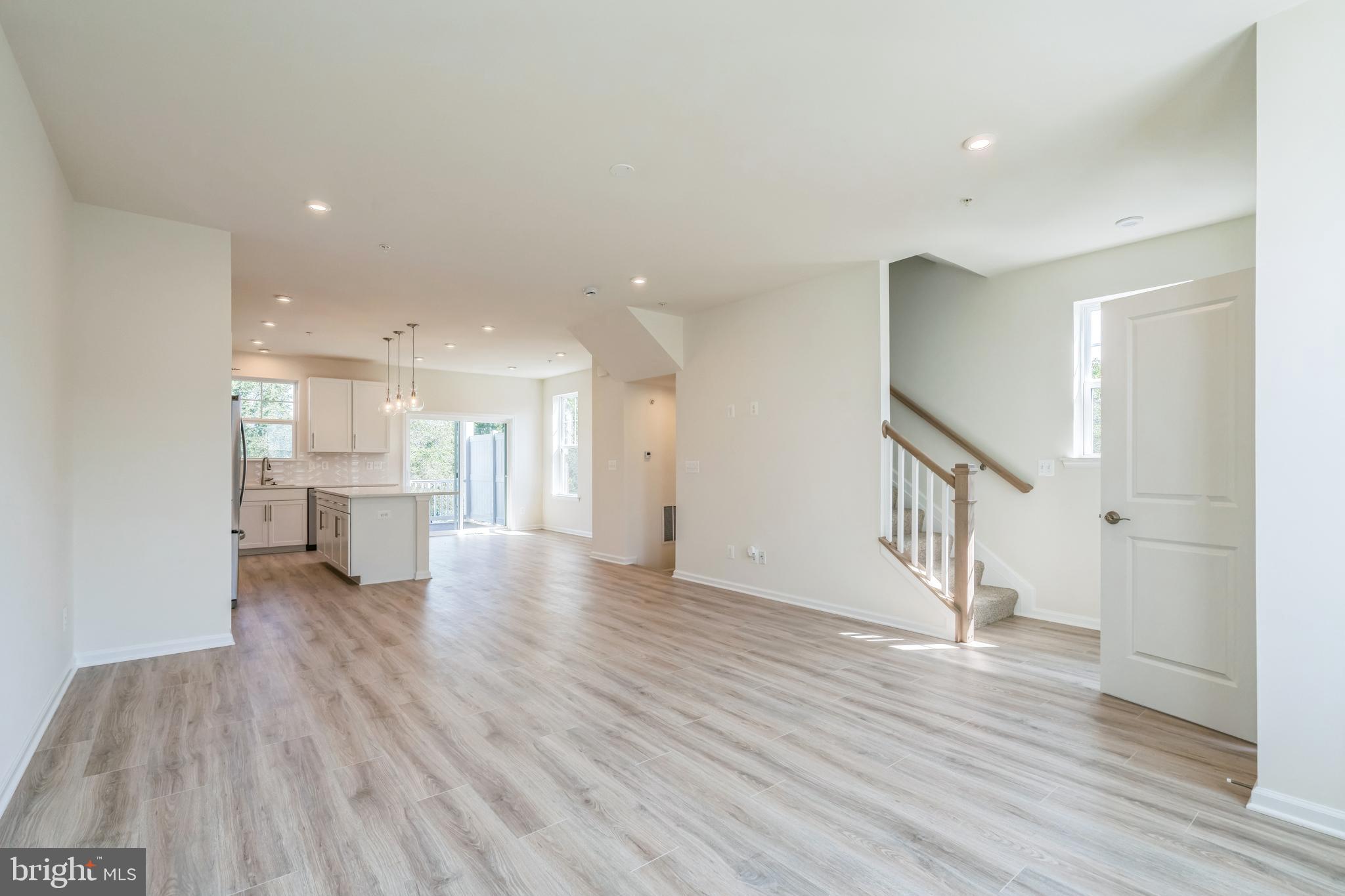 2 Riverside Wharf Cambridge, MD 21613 - Photo 6 of 38 a view of a hallway with wooden floor and a kitchen
