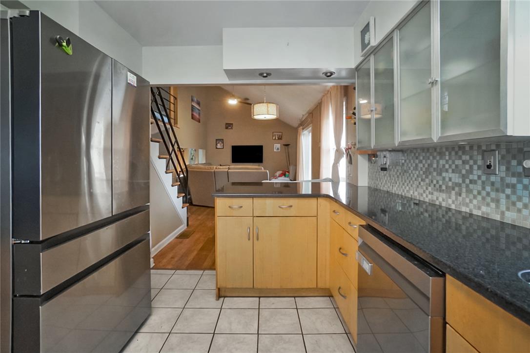 3031 Shakespeare Road Bethlehem, PA 18017 - Photo 9 of 30 A well-appointed kitchen features stainless steel appliances and ample counter space, seamlessly connecting to the living area. Picture has been digitally enhanced.