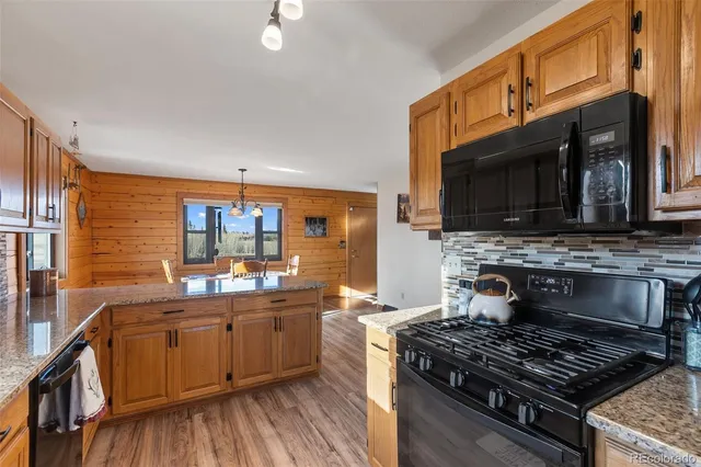 a kitchen with stainless steel appliances a stove sink and cabinets