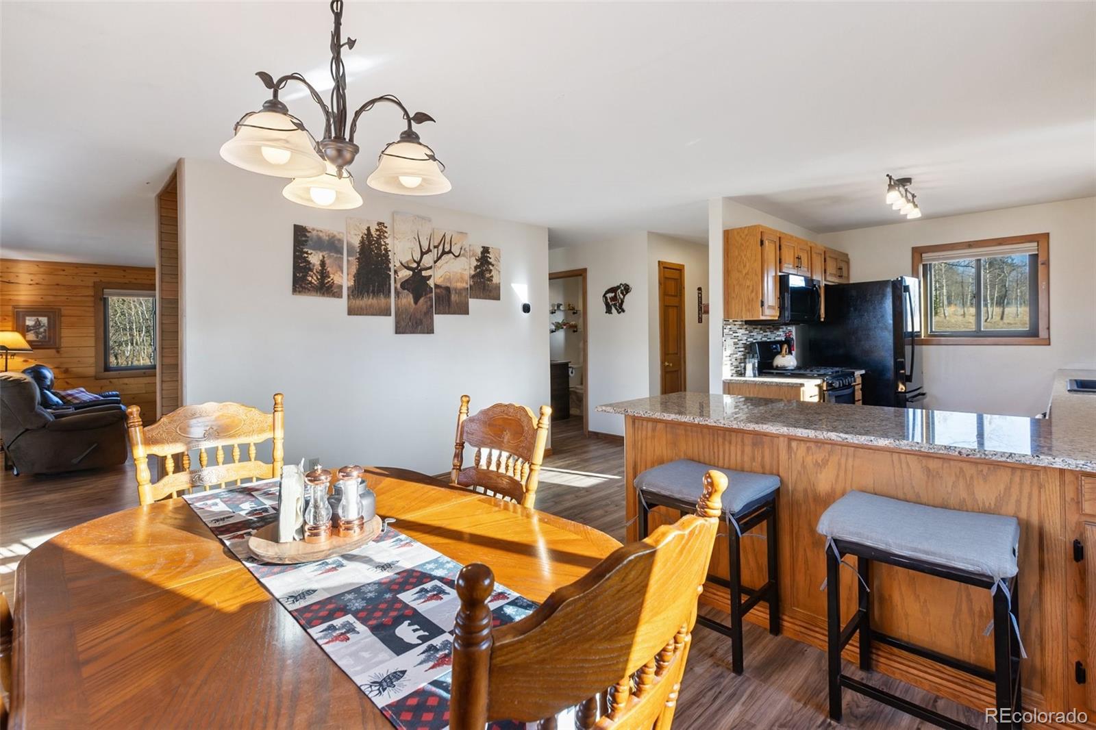 2387 Buffalo Ridge Road Como, CO 80456 - Photo 13 of 50 a living room with furniture a flat screen tv and kitchen view