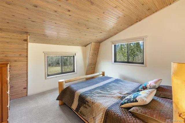 a bedroom with bed and a window