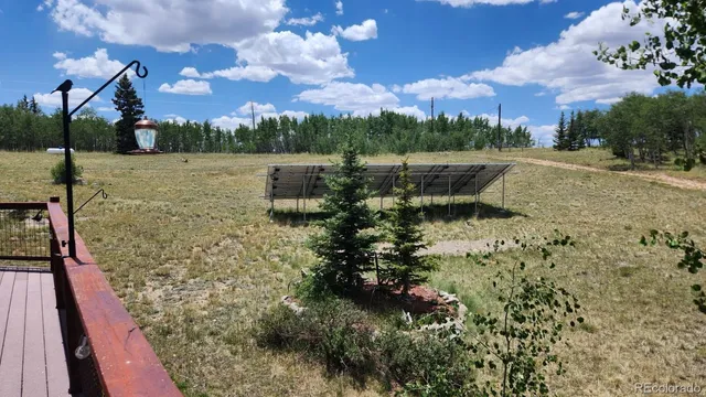 a view of a lake with table and chairs