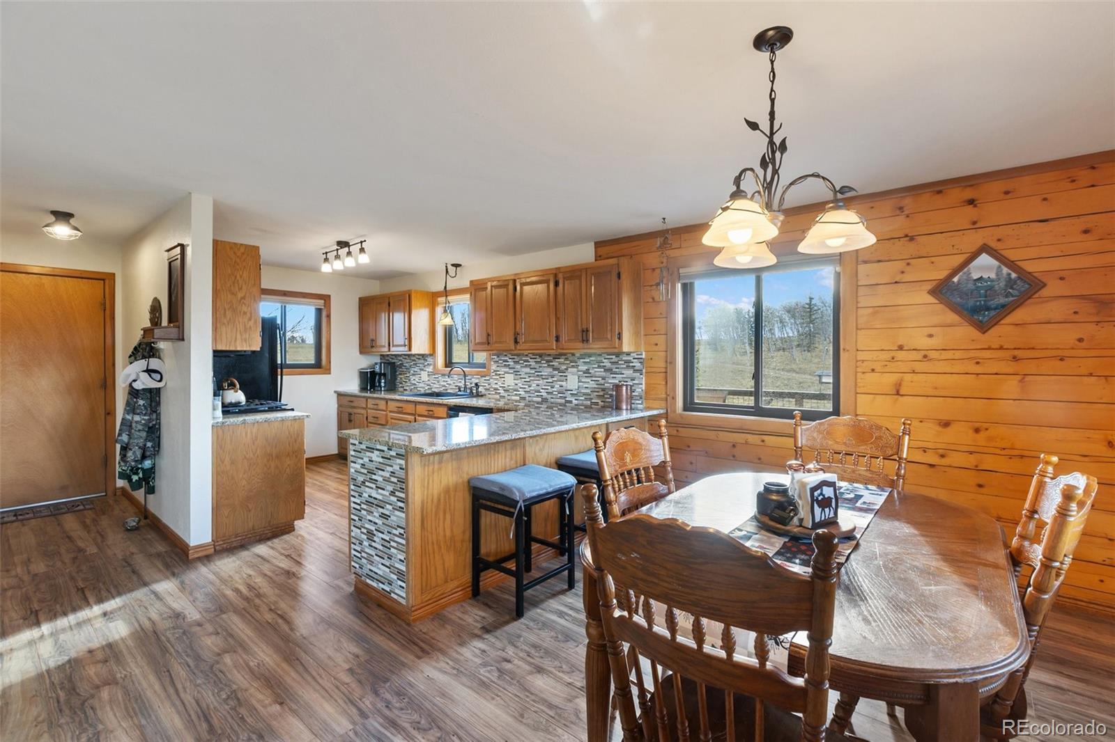 2387 Buffalo Ridge Road Como, CO 80456 - Photo 9 of 50 a view of a dining room and livingroom with furniture wooden floor a chandelier