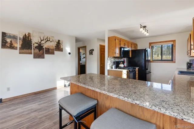 a living room with kitchen island furniture and a wooden floor