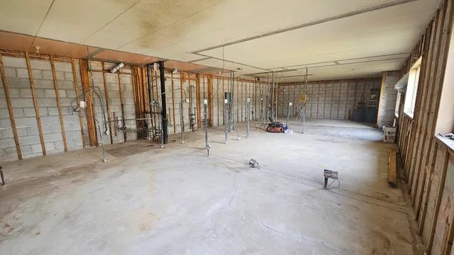 a view of a garage with wooden floor and fence