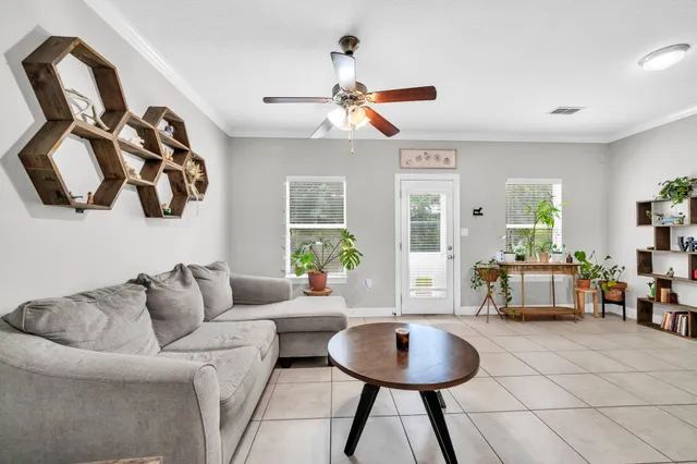 a living room with furniture and a chandelier