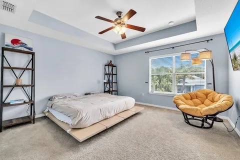 a bedroom with a bed and a large window