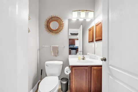 a bathroom with a toilet a sink and a mirror