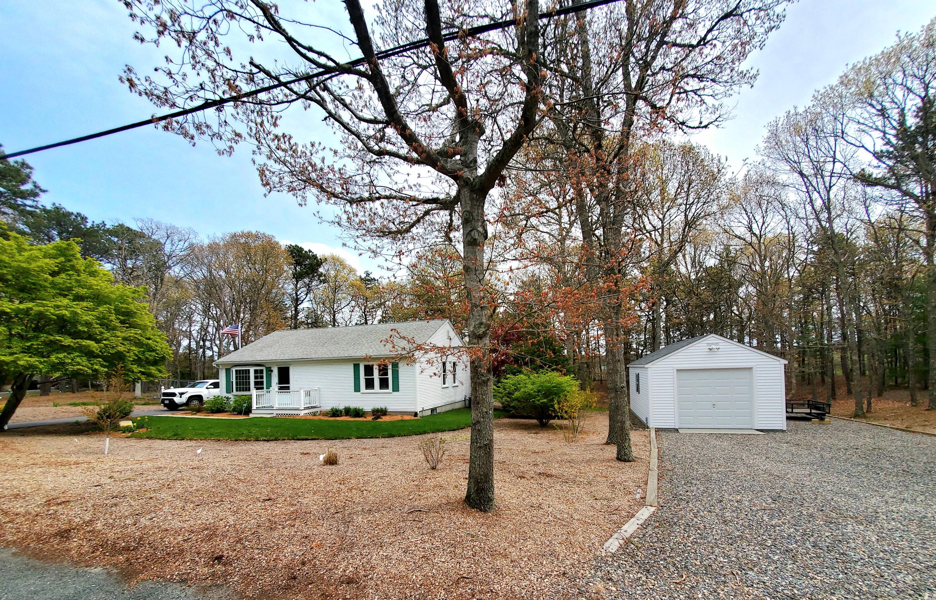 52 Thayer Road Dennis, MA 02660 - Photo 19 of 19 a view of house with garden and trees
