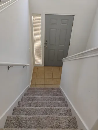 a view of a hallway with chandelier