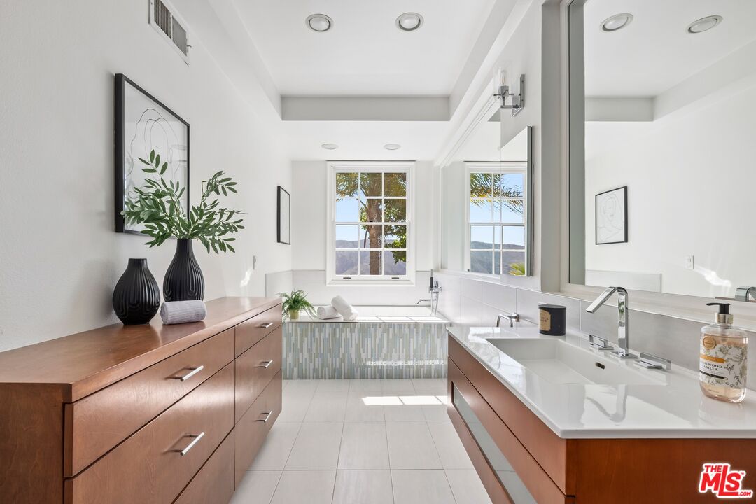 2241 Canyonback Road Los Angeles, CA 90049 - Photo 15 of 26 a large white kitchen with a large window