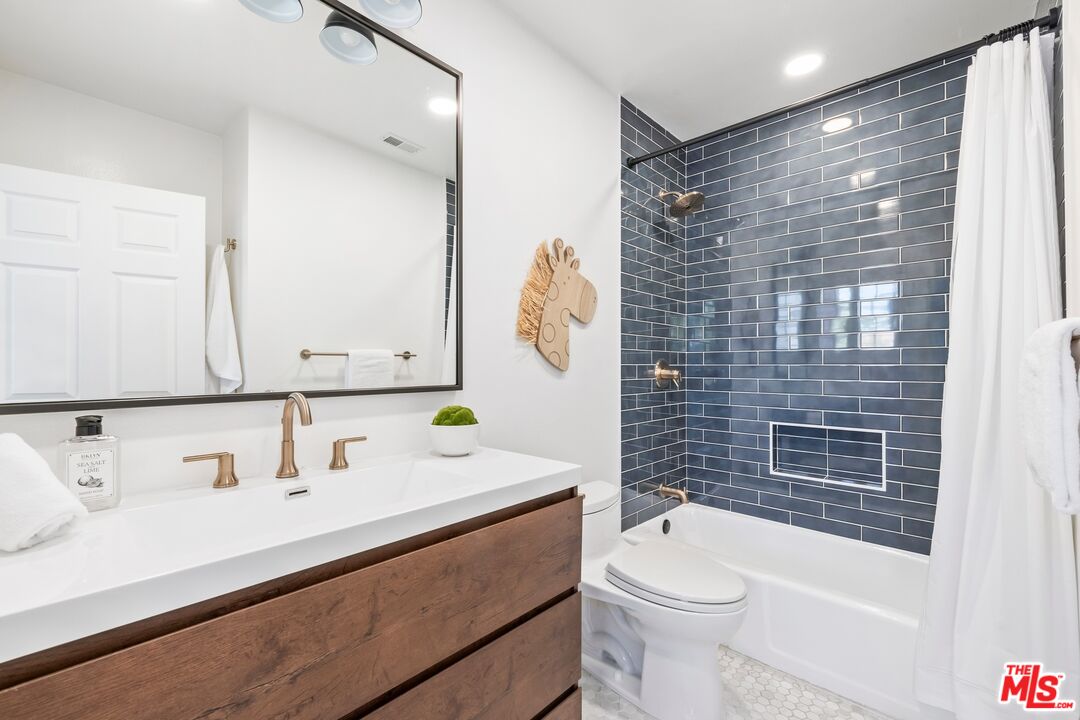 2241 Canyonback Road Los Angeles, CA 90049 - Photo 20 of 26 a bathroom with a sink a toilet and shower